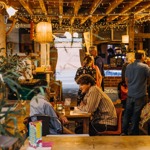 The inside of Hagglers Corner, where people are sat at tales dining.