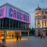 Sheffield Theatres shown at dusk with the Crucible Theatre name illuminated 