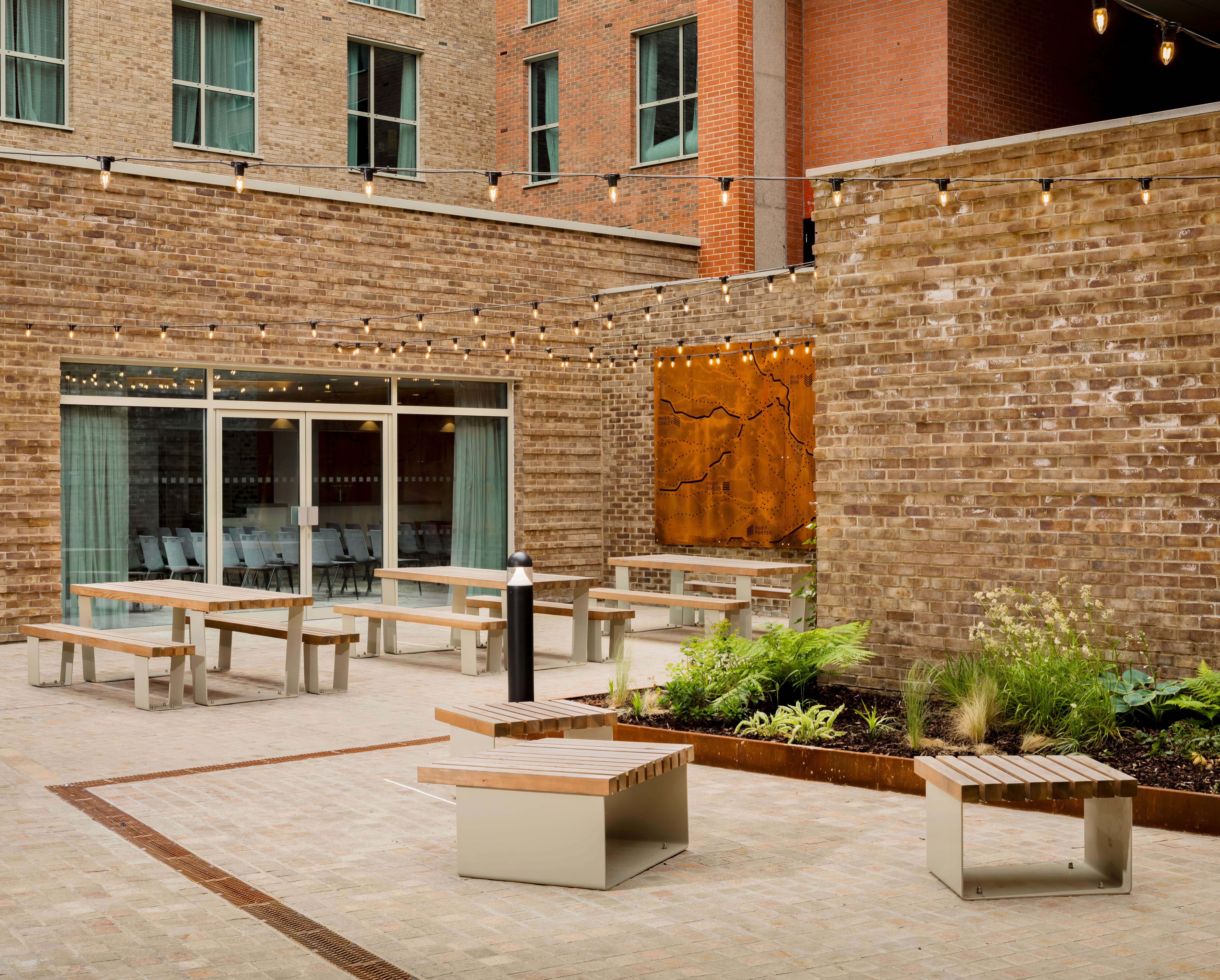 Outdoor area with benches and planted garden.
