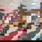 Bedroom featuring a double bed positioned near a window with natural light.