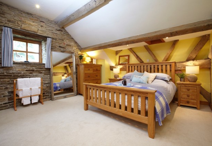 Bedroom at Smallshaw Cottages & Spa featuring a double bed with crisp linens, bedside tables, and soft ambient lighting.
