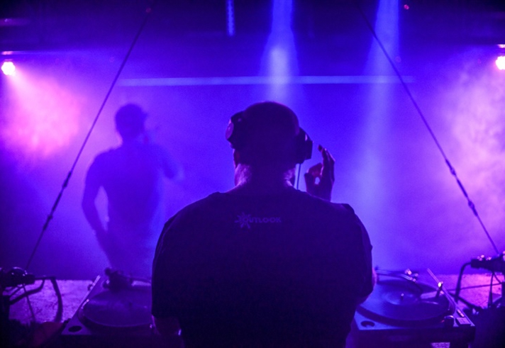 A DJ playing in a nightclub.