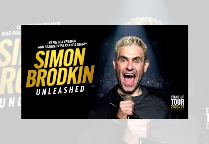 Promotional tour poster featuring a person holding a microphone under a spotlight against a dark stage background. Large yellow and white text reads: “Simon Brodkin Unleashed.” Smaller text above states: “Lee Nelson creator who pranked FIFA, Kanye & Trump.” Additional text on the right reads: “Stand-Up Tour 2026/27.” The design uses bold typography and a high-contrast black and gold colour scheme.