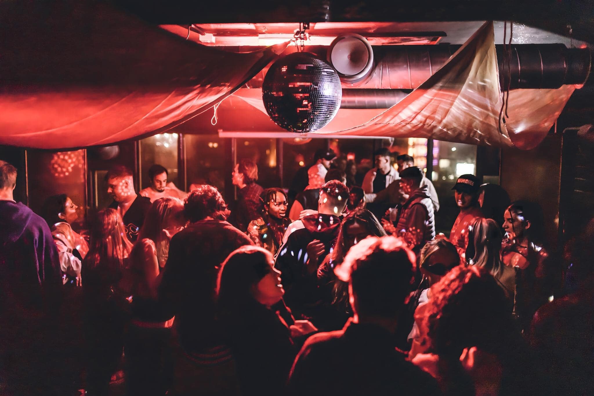 Disco ball above people dancing at Panke Social 