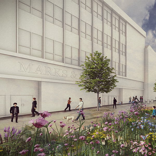 Street-level view of a modern building with large windows and the words ‘Marks &’ faintly visible on the facade. People are walking along a wide pavement lined with trees and colorful flower beds in the foreground.