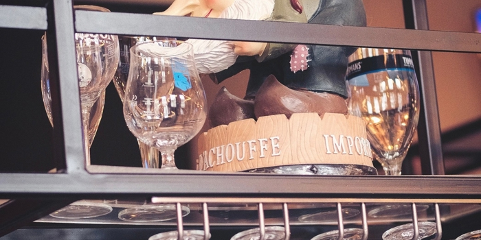 A model of a pirate hiding on am overhead glass rack, above the bar.