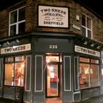 The exterior of the Two Sheds at night.
