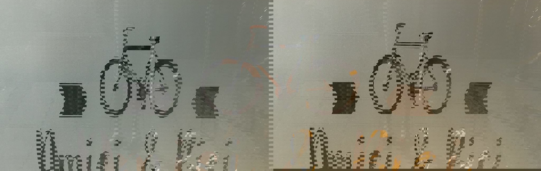 The Amici & Bici logo picked out in frosted glass on the restaurants window.