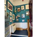 Walls covered in framed pictures at All Good Stuff.