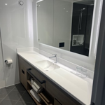 Bathroom with a sink and a mirror mounted above it.