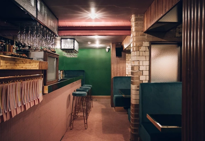 The interior of the bar Public, in Sheffield city centre, showing off the beautiful dark wood and green velvet interior. 