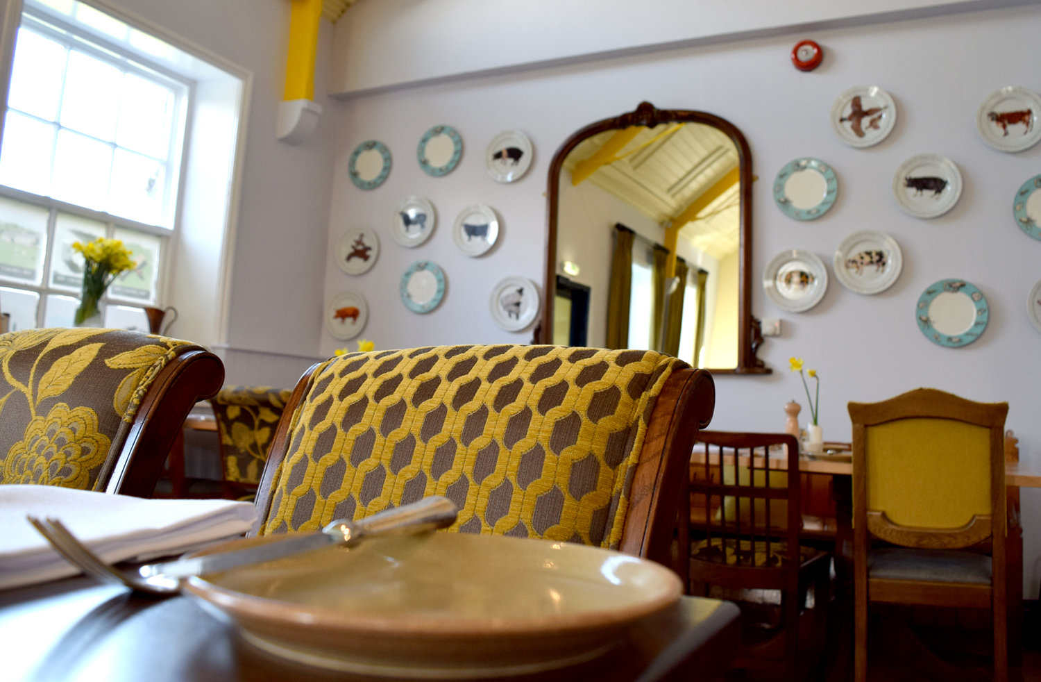 A close up of a table and upholstered chairs at The Cricket Inn.