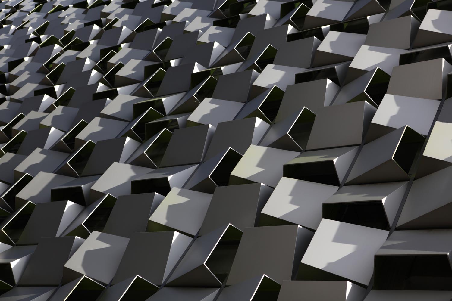 An artistic close up of the tessellated steel boxes that form the facade of a building in central Sheffield.   