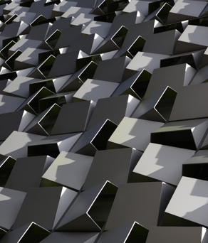 An artistic close up of the tessellated steel boxes that form the facade of a building in central Sheffield.   