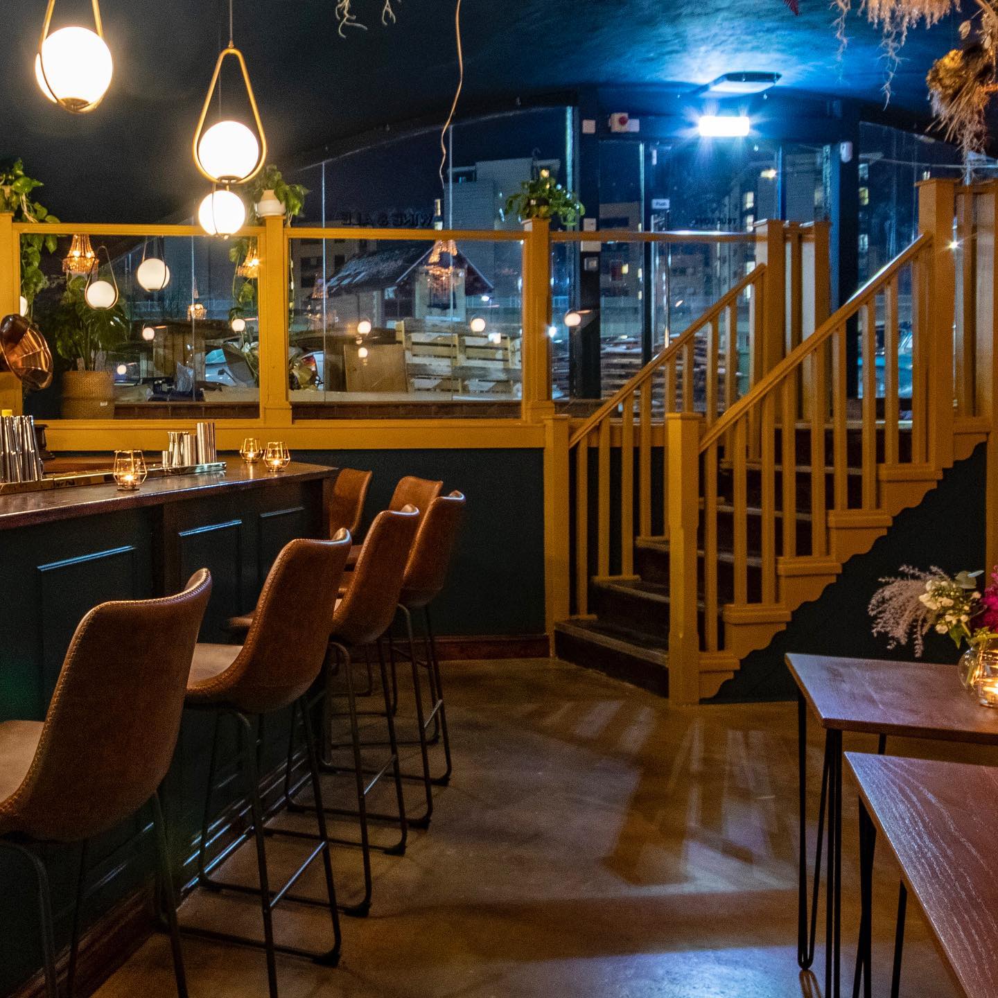 Seating and tables under the vaulted ceiling at True Loves.