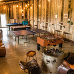 Bright games room with table tennis, pool table, table football and sofas in a Sykes Holiday Cottage.