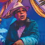 Craig Charles looking dapper in a hat and shades.