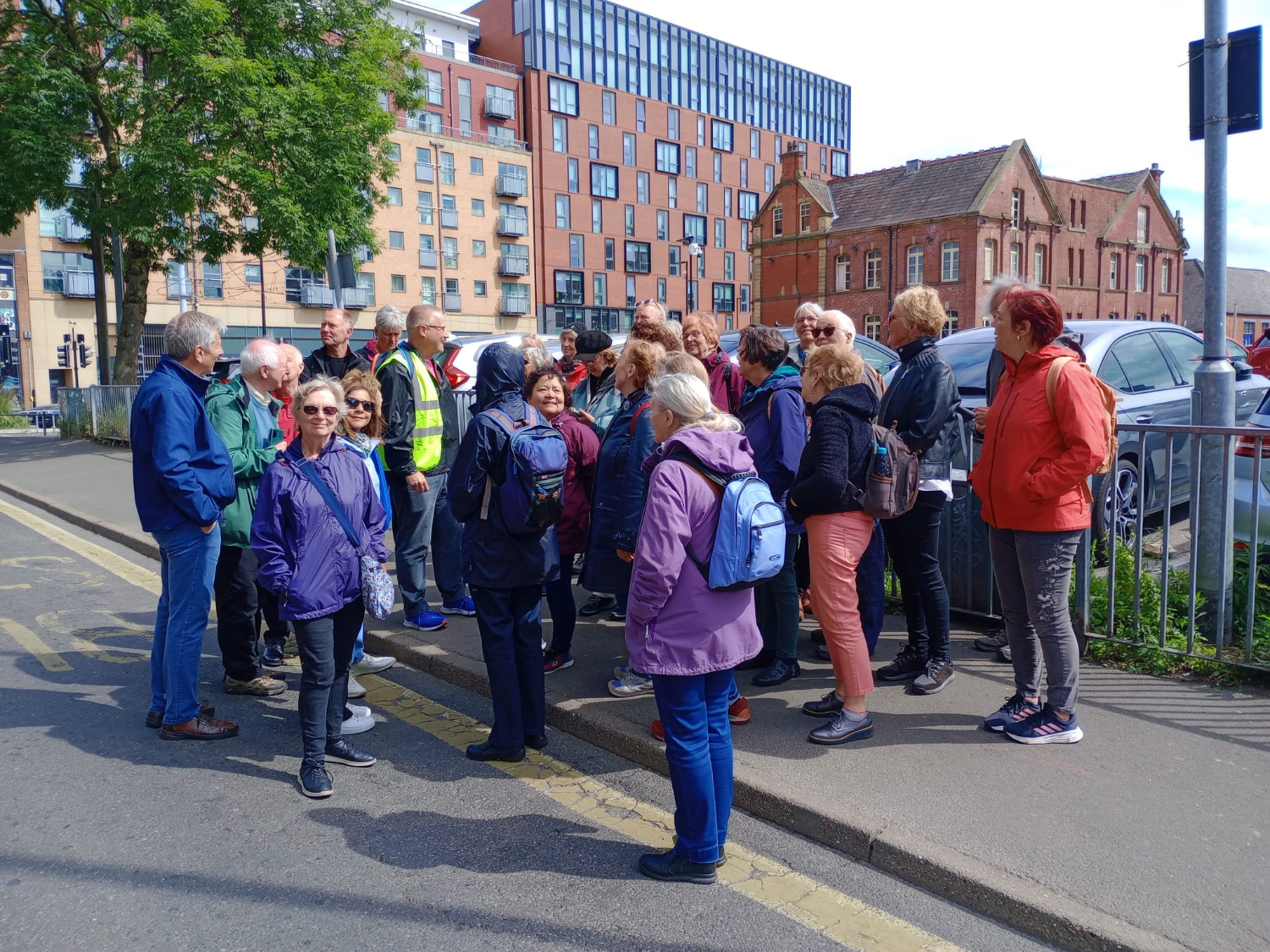 A tour guide talks to a group of people on a tour in Sheffield.