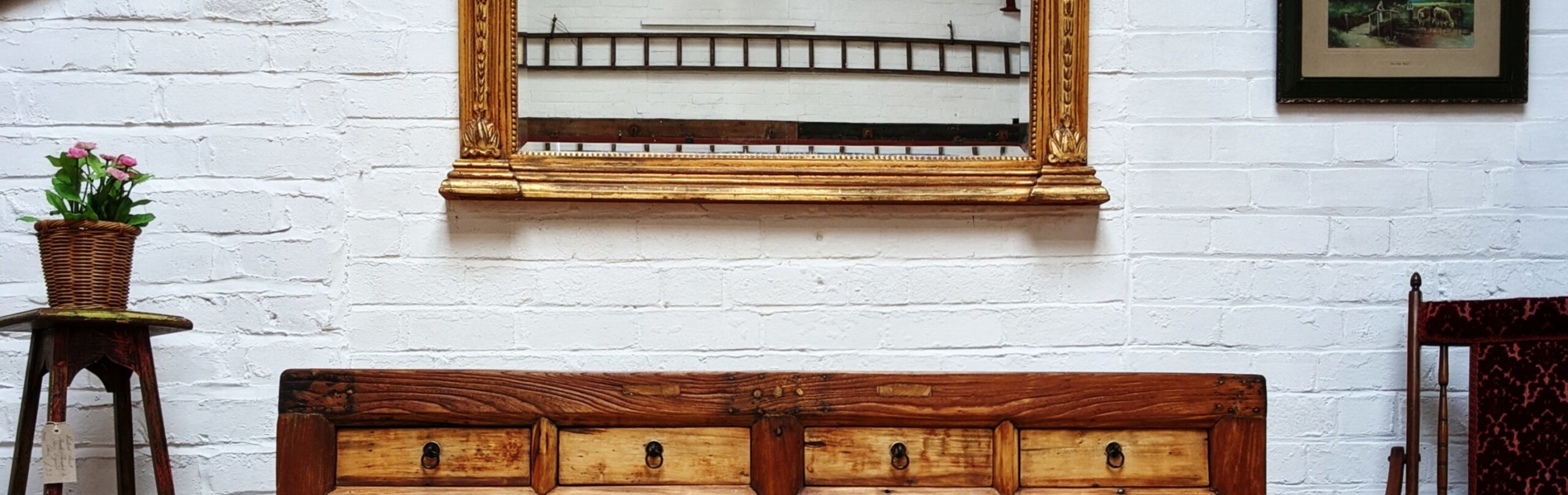 A large sideboard and  large wall mirror on display at The WareHouse.