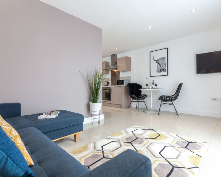 Living room at K Space @ The Point with sofa and modern décor.