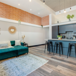 Modern living room with a kitchenette in the same open-plan space.