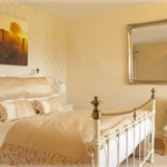 A double bed in a nicely decorated room.