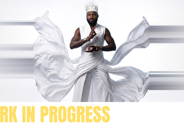 A promo image featuring a man in flowing white robes.