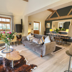 Comfortable living room in a Sykes Holiday Cottage with sofa and coffee table.
