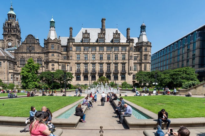 Crowds of people in the Peace Gardens on a sunny day in Sheffield.