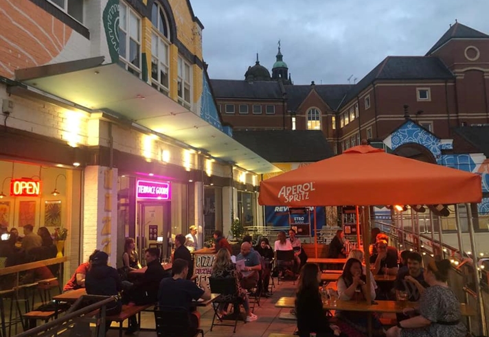 People dining outside at Terrace Goods, in the evening.