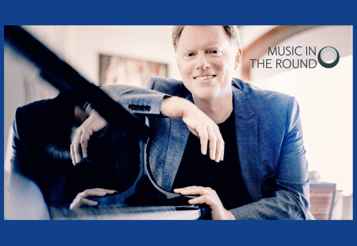 Tim Horton sat at a grand piano.