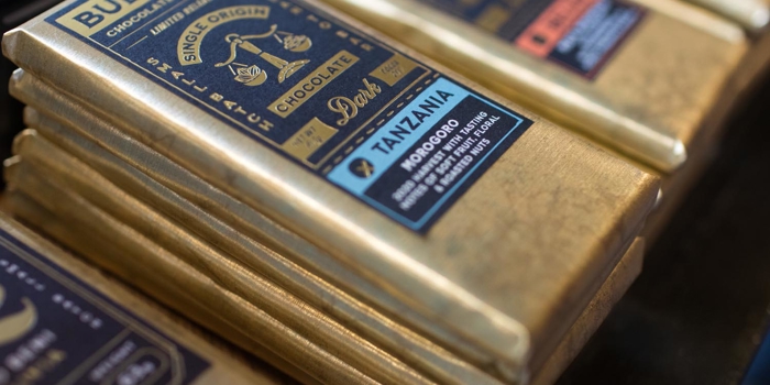 A close-up of bars of Bullion chocolate stacked up on a display.