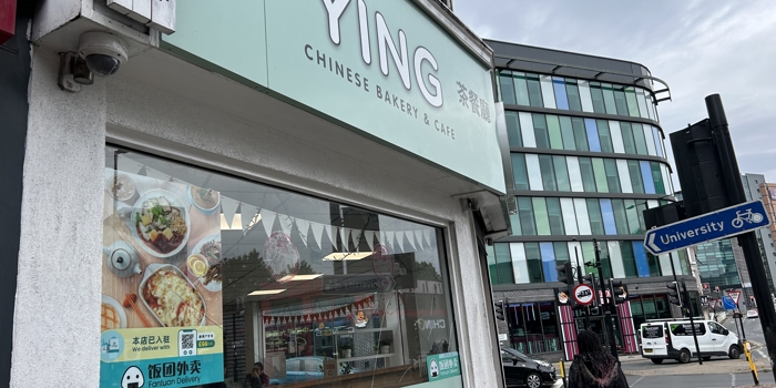 a picture outside the shop which shows the sign on top which reads Ying Chinese bakery and cafe