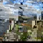 A building, in the countryside, overlooking a valley.