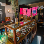 The counter at North Town, with a glass case filled with goods for sale.