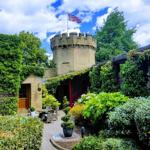Well-maintained hotel garden with plants, trees, and pathways at the Garrison Hotel.