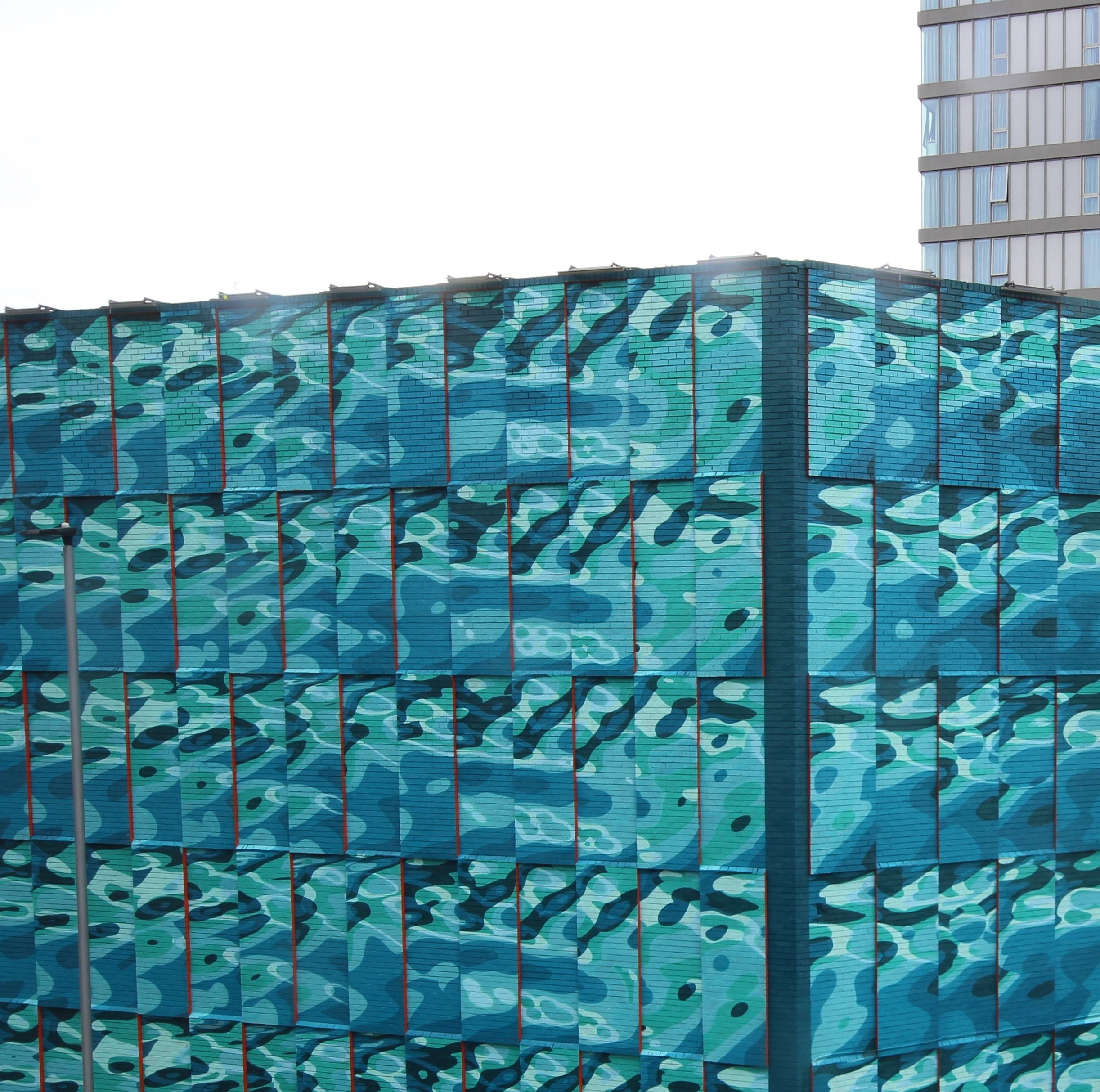 A close up view of INSA's Rivers street art showing the corner of the building 