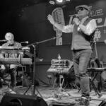 Black and white picture of musicians performing om stage.