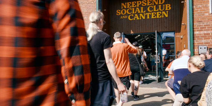 People walking into Neepsend Social Club, with distinct signage above the doorway 