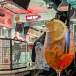 A close up of a cocktail with a band playing in the background.