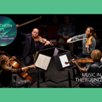 A string quartet, sat in a circle facing inwards, are performing on a stage.
