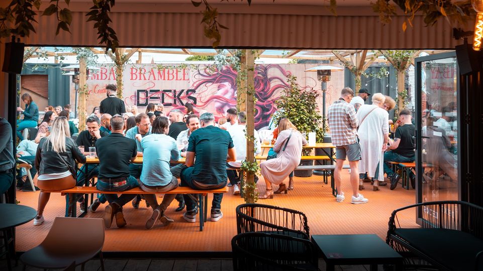 Groups of people sat at tables at Decks.