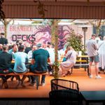 Groups of people sat at tables at Decks.
