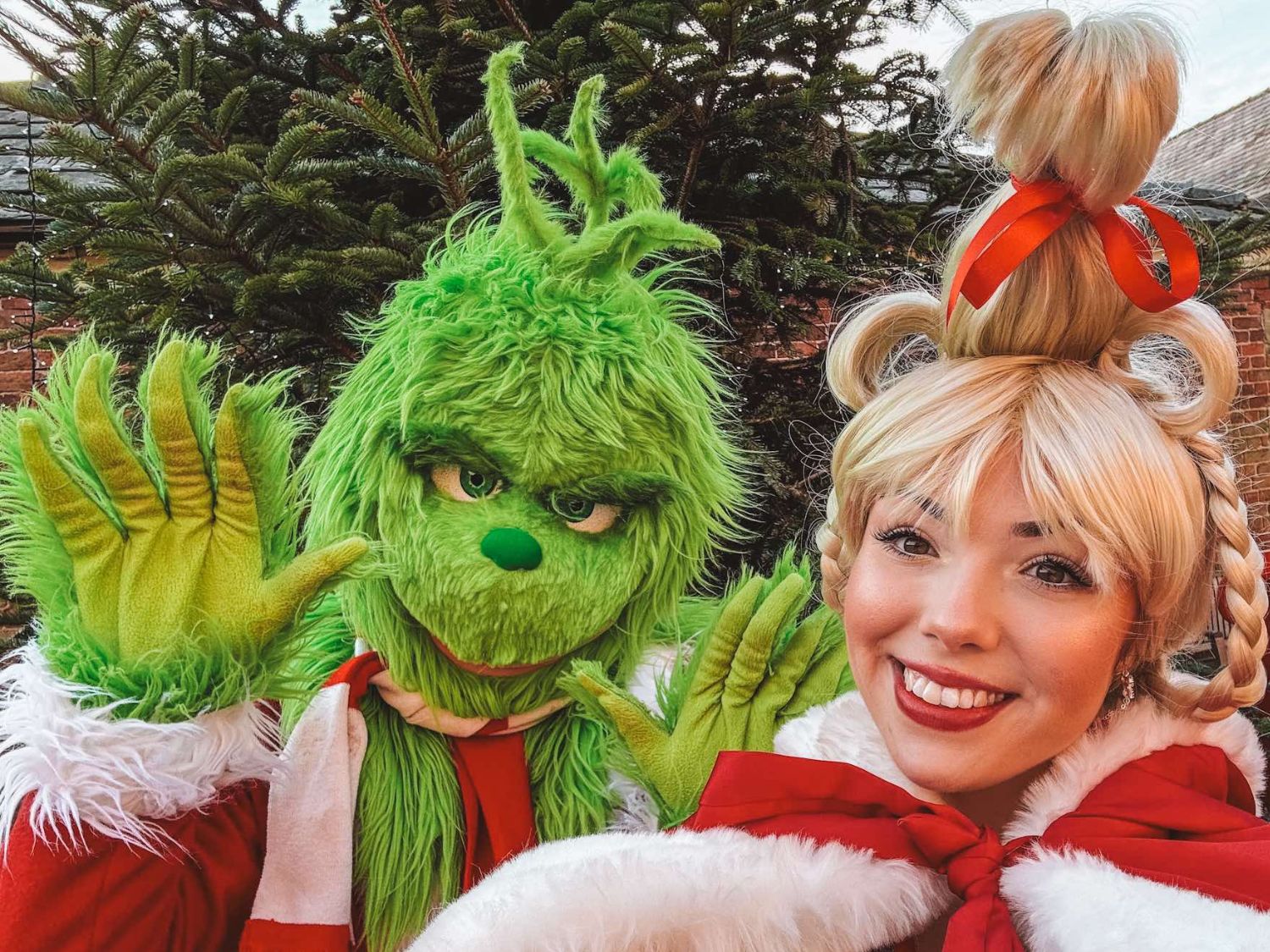 Two people dressed as the Grinch and Cindy Lou Who.