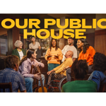 A group of 10 people standing and sitting together in a pub setting.