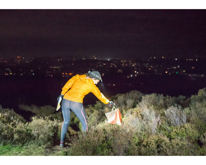 A person in running gear, with a head torch, is Night Orienteering.