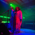 A woman sings live on the stage at Yellow Arch.