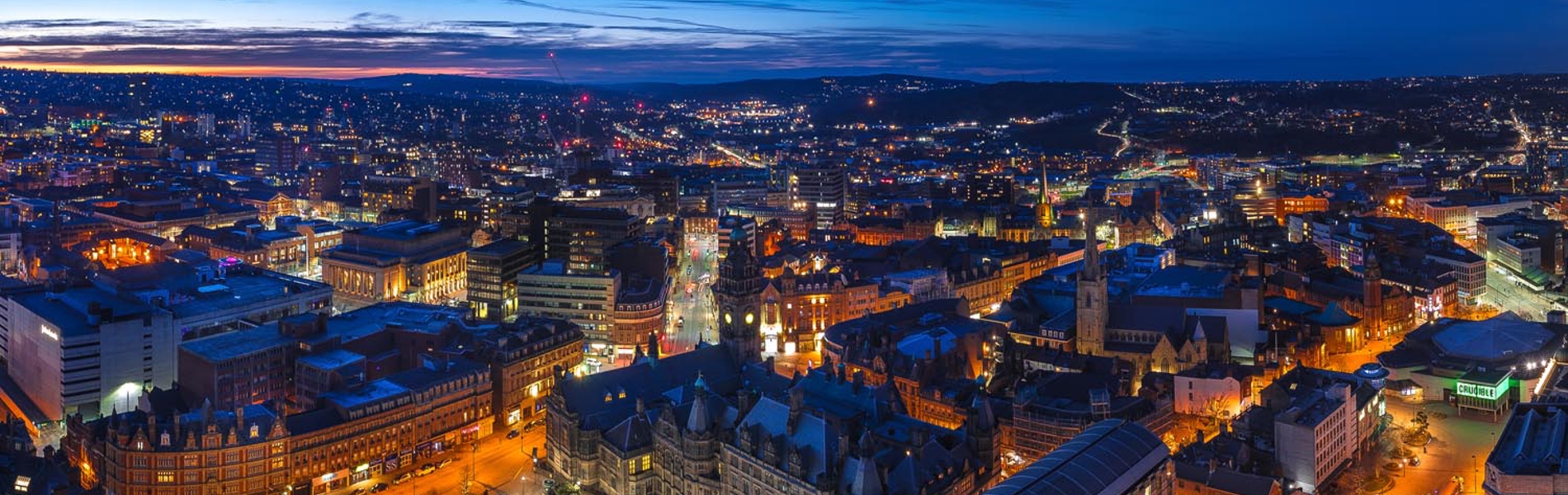 A panorama shot of the Sheffield skyline at night.