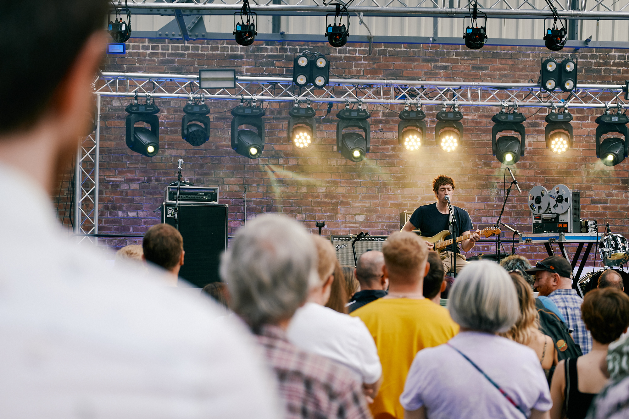 view from crowd of artist singing and playing guitar at Get Together 2023