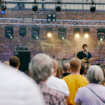 view from crowd of artist singing and playing guitar at Get Together 2023